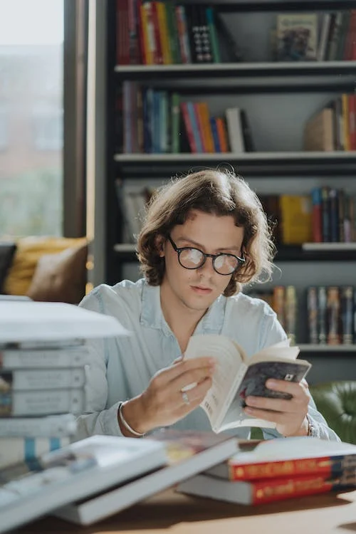 A male student reading a book