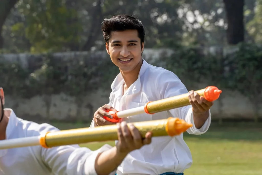 Men in white long sleeves playing with a toy water gun