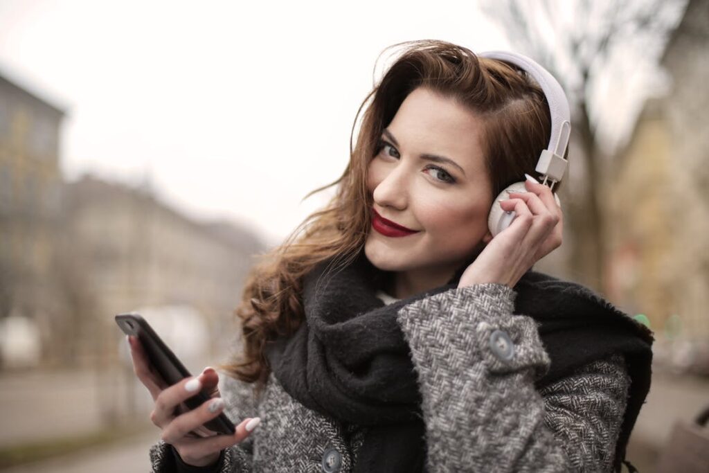a-photo-of-a-woman-listening-to-music-on-white-headphones