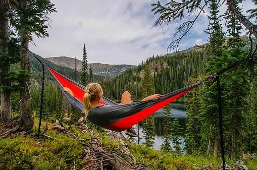 A woman enjoying the scenery while lying in the hammock