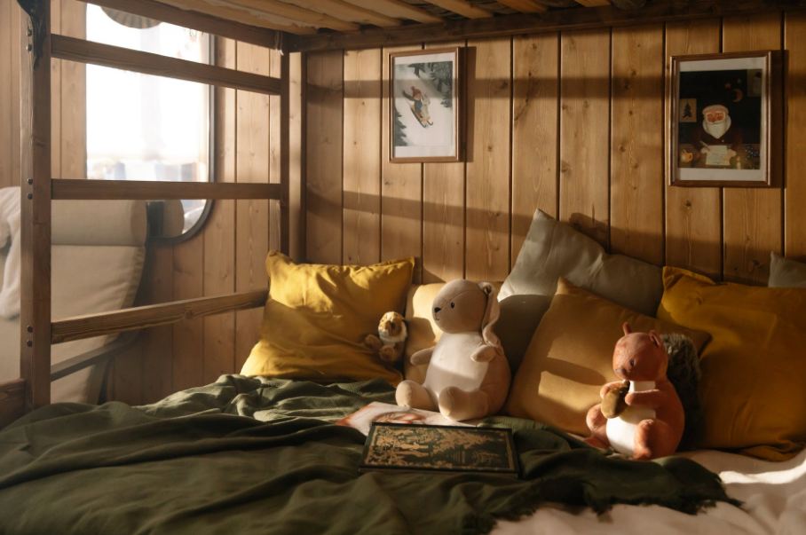 Plush toys kept on a bohemian-style bed. 