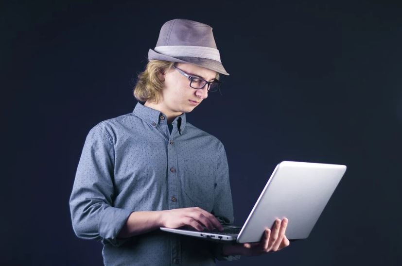 a geeky person holding a laptop
