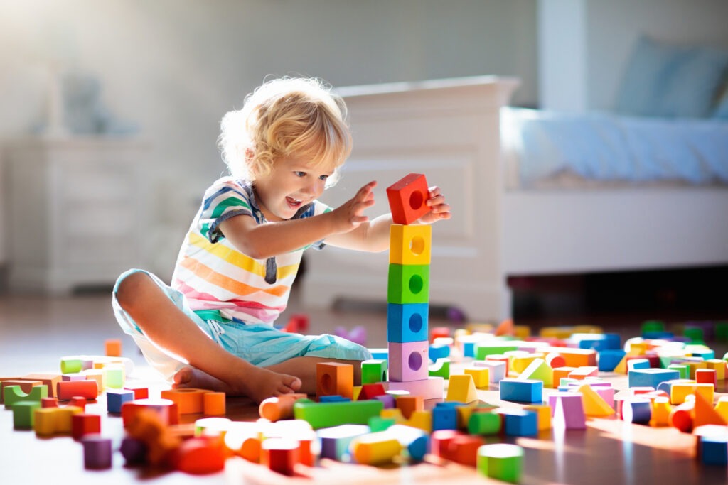 A child happily playing with colorful building blocks