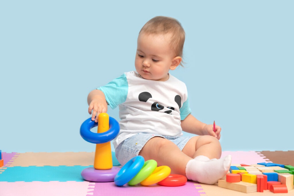 Baby playing with colorful stackable toy