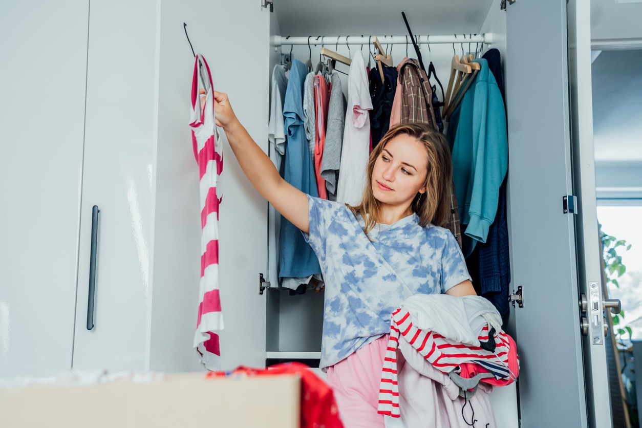 Woman looking at her many wardrobe